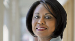 Portrait of Anita Hill posing in long hallway.